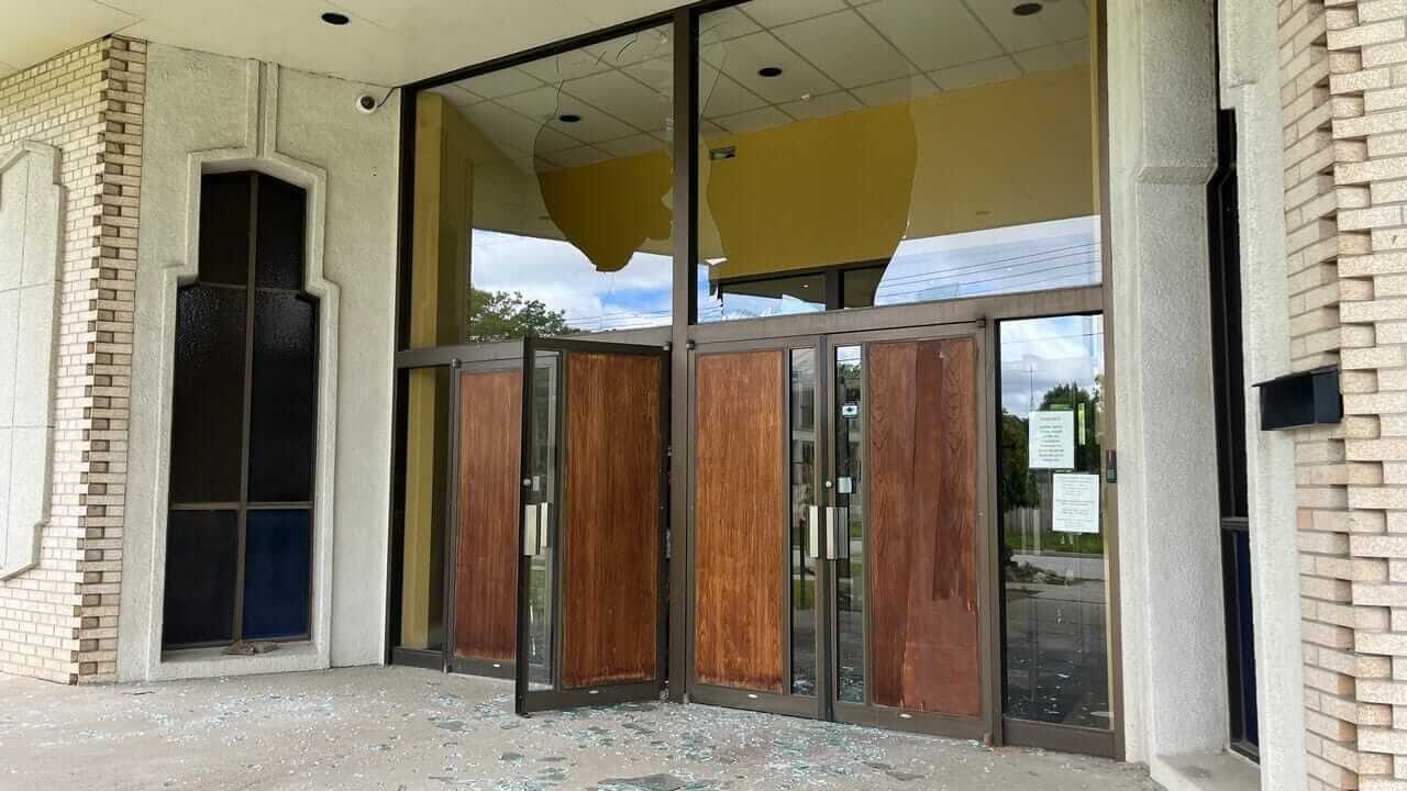 Damaged commercial glass entry door after vandalism