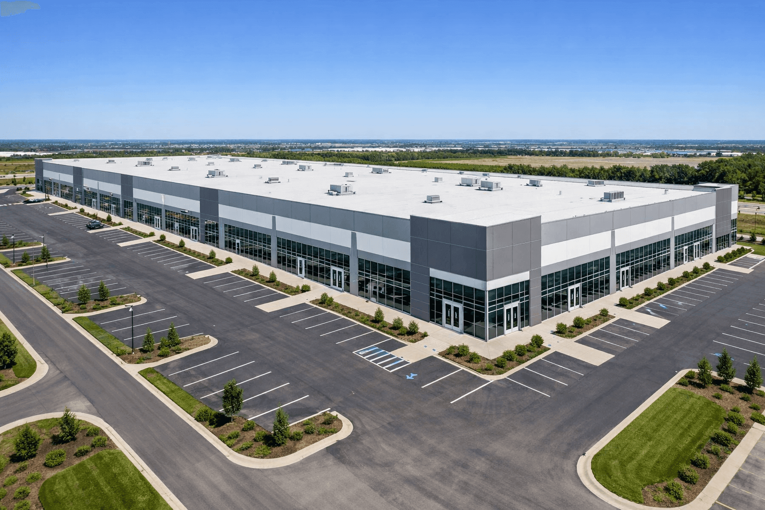 Large commercial industrial building with secure glass, window, and door protection.